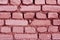 Pink weathered brick wall texture.