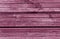 Pink weathered wooden wall texture.