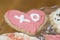 Pink and white frosted heart Valentine cookie with the letters X
