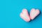 Pink and white marshmallow hearts in doodle style on mint blue background. Romance Valentine Charity Concept. Greeting Card Poster
