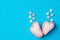 Pink and white marshmallow hearts flying candies in doodle style on mint blue background. Romance Valentine Charity