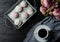 Pink and white marshmallows on a dark background on a vintage tray and bouquet of flowers