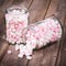 Pink and white marshmallows spilling from a storage jar,