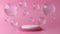 Pink and white round stage, pedestal or podium and water and glass bubbles or spheres. Pink pastel background advertisement.