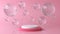 Pink and white round stage, pedestal or podium and water and glass bubbles or spheres in pink studio. Pink pastel background