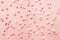 Pink and white star shaped sprinkles on light pink background. Colourful edible cake decoration on pink background