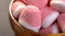 Pink white sugar marmalade candies in rustic wooden bowl. Red jelly candy. Macro.