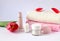 Pink and white terry towels, body care products, scarlet tulip on a white background, side view-the concept of taking care of your