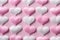 Pink and white textile hearts on pink background