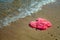 Pink Women`s JELLY SANDALS on a sea shore. LADIES FLAT JELLIES SUMMER BEACH SHOES.