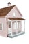 Pink wooden dollhouse on white