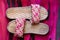 Pink woven slippers on the textures