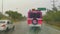 Pink Xcaret bus drives in heavy rain on highway Mexico