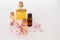 Pink and yellow essential oil and bottled water for aromatherapy and SPA on white background