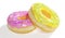 Pink and yellow frosted donut with colorful sprinkles. 3D Illustration.