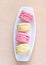 Pink and yellow macaron on a plate