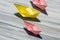 Pink and yellow paper folded, origami, boats on a rock
