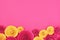 Pink and yellow rose flat lay background with crafted paper flowers at bottom and empty copy space