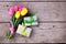 Pink and yellow spring tulips and boxes with presents on vintag