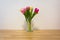 Pink Yellow Tulips Wooden Table White Wall Glass Vase