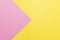 Pink and yellow two colours paper geometrical triangular background. Pink triangle on yellow background