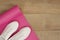 Pink yoga mat and white trendy sneakers on a wooden background. Fitness concept, active lifestyle, body care concept. Wood Backgro