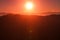 Pinkish Sunrise over a Mountain Horizon
