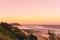 The Pinky sunset in summer time on the beach in Ballina with ocean view and the hilly landscape, Byron b