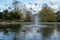 Pinner Memorial Park, Middlesex, UK taken on a sunny partially cloudy spring day, showing lake with fountain, birds, ducks