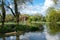 Pinner Memorial Park, UK. Photo shows lake with fountain, birds, ducks, geese, trees and green foliage.