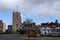 Pinner Parish Church in the High Street, Pinner Middlesex, UK with historic half timbered Tudor building in front. Primula flowers