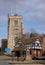 Pinner Parish Church in Pinner High Street, UK, with historic half timbered Tudor building and war memorial in the foreground.