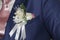 Pinning the Groom with boutonniere flowers