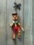 Pinocchio wooden puppets appear to be running ahead with a rustic wooden background