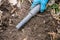 Pinpointer metal detector in digger archaeologist hand and ancient coin.