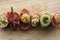 Pintxo Set: Olive, Anchovy, Cherry tomato, kiwi, Raisin, Cured Ham, Mushroom, bread in a rustic board