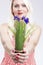 Pinup Caucasian Woman Holding Bunch of Vivid Lilac Flowers In Fr