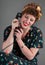 Pinup Girl in Flowered Outfit Laughs While on the Telephone
