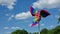 Pinwheel against the blue sky with clouds. Rainbow windmill.