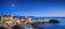 Piombino old town twilight panoramic view on piazza bovio lighthouse and rocks. Tuscany Italy