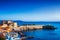 Piombino old town twilight panoramic view on piazza bovio lighthouse and rocks. Tuscany Italy