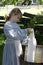 Pioneer girl with Old fashioned washboard with laundry outside