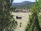 Pioneer Home by a Stream in a Green Meadow in the American West