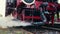 Pipe of old historic German locomotive releases thick clouds of steam