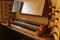 Pipe organ console with two keyboards also called manuals and wooden stop knobs for registration in the St. Mary`s Church of Gudo