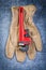 Pipe wrench safety gloves on metallic background construction co