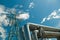 pipeline and power line support, in the photo pipeline and power line tower close-up against the background of blue sky and clouds