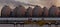 Pipelines and fuel tanks in the fuel warehouse in the light of the setting sun against the background of the refineries