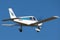 Piper Cherokee PA-28-140 single eying light aircraft VH-ETI flying against a blue sky