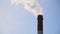 Pipes smoke: industrial production, plant, air pollution Dense thick smoke comes from industrial red-white pipes:  bird`s eye view